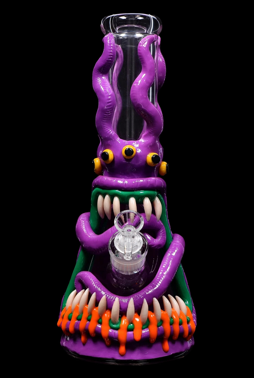 A vibrant glass water pipe shaped like a monster, featuring purple tentacles, glowing green eyes, and a menacing grin with orange teeth.
