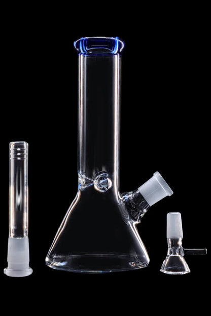 Clear glass bong and accessories on a black background.