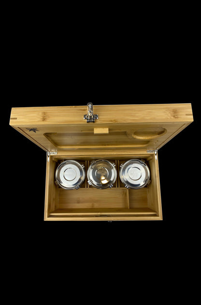 Wooden cannabis storage box with three glass jars inside, viewed from above.