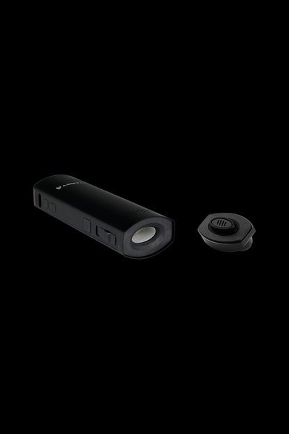 Black cannabis vaporizer pen and detachable mouthpiece on a dark background.