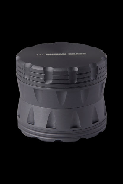 Black four-piece metal cannabis grinder.