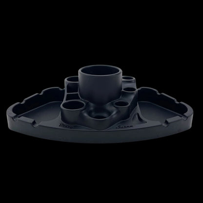 Front-facing studio shot of a matte green Blazy Susan Deluxe Dab Station with central cup and multiple recessed holders against a black background