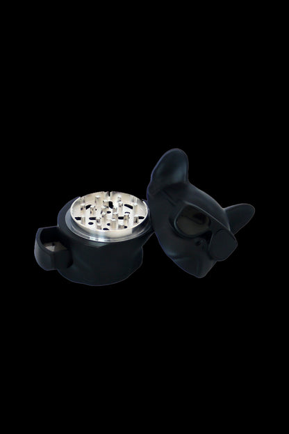Black cat-shaped grinder for cannabis, open to reveal the grinding teeth.