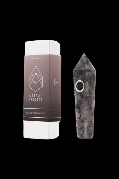 Black tourmaline gemstone pipe and its white packaging with a geometric logo.