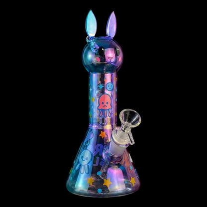 Angled close-up of the iridescent Croia Glass Cute Bunny Beaker Bong with Tree Perc showing its bunny head, stickers, and bowl.
