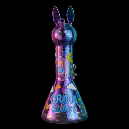 Centered front view of the Croia Glass Cute Bunny Beaker Bong with Tree Perc showing its iridescent bunny head and starry decals