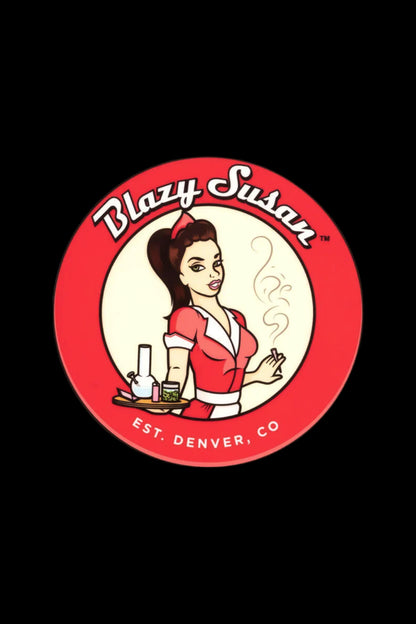 A circular logo for “Blazy Susan” featuring a vintage-style illustration of a woman holding a glass cannabis pipe, with cannabis buds and accessories on a tray, and text “Est. Denver, CO”.