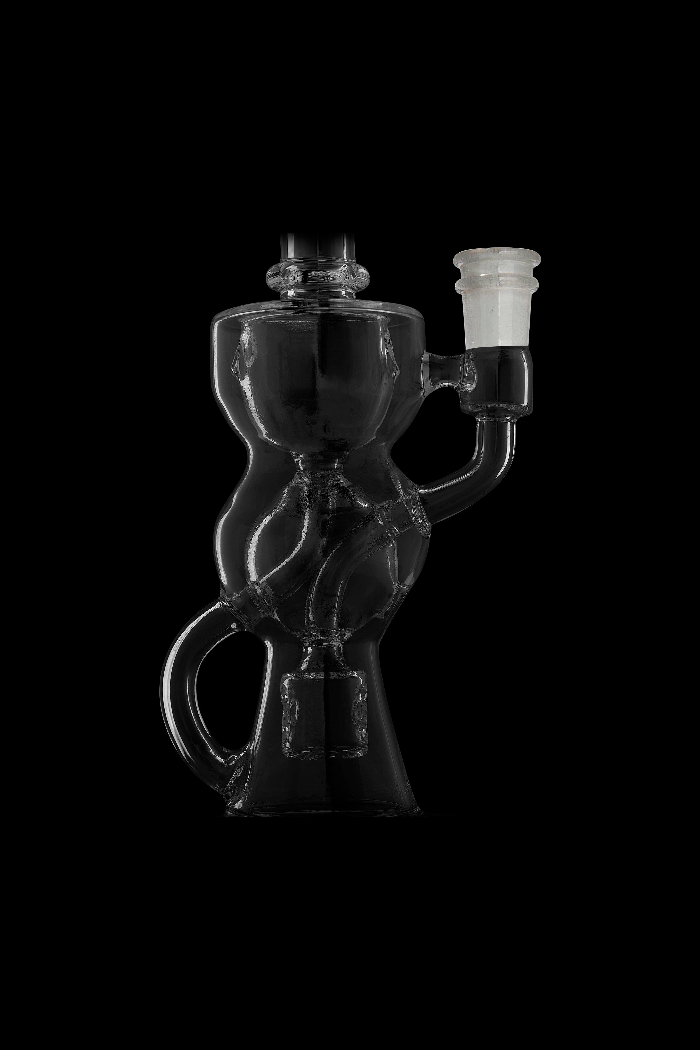 Clear glass water pipe (rig) with intricate bubbler design against a black background.