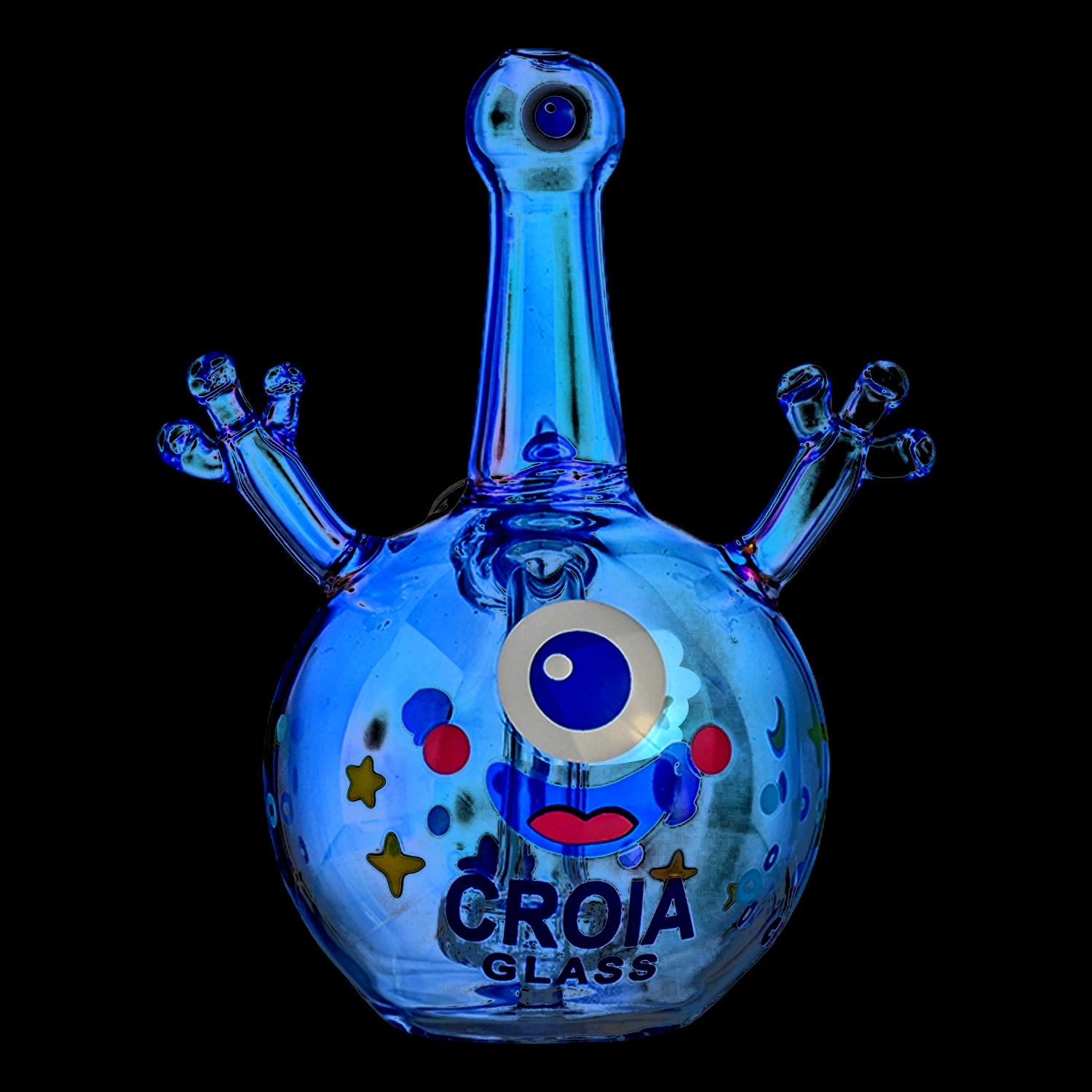Close-up front view of the Croia Glass Cyclops Monster Mini Dab Rig with Showerhead Perc showing a glossy blue one-eyed monster face and raised arm-like percs against a black background.
