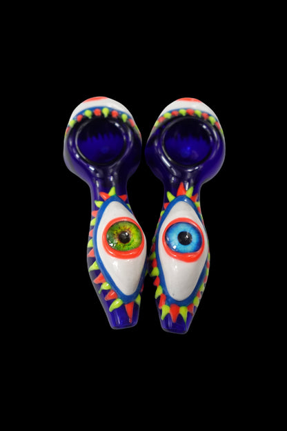 Two colorful glass pipes shaped like eyes with detailed iris and pupil designs, against a black background.