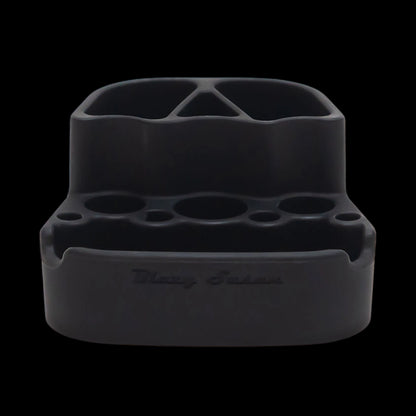 Close-up front view of the Blazy Susan Dab Station in red showing its divided top compartments and multiple circular tool slots against a black background