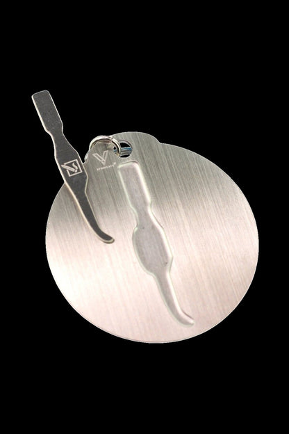 Silver dab tool with a circular, brushed metal background.