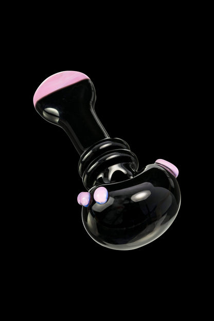 Glossy black glass oil rig with iridescent pink accents, floating against a black background.