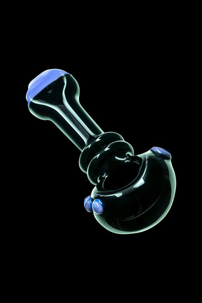 Black glass bubbler with blue accents, isolated on a black background.