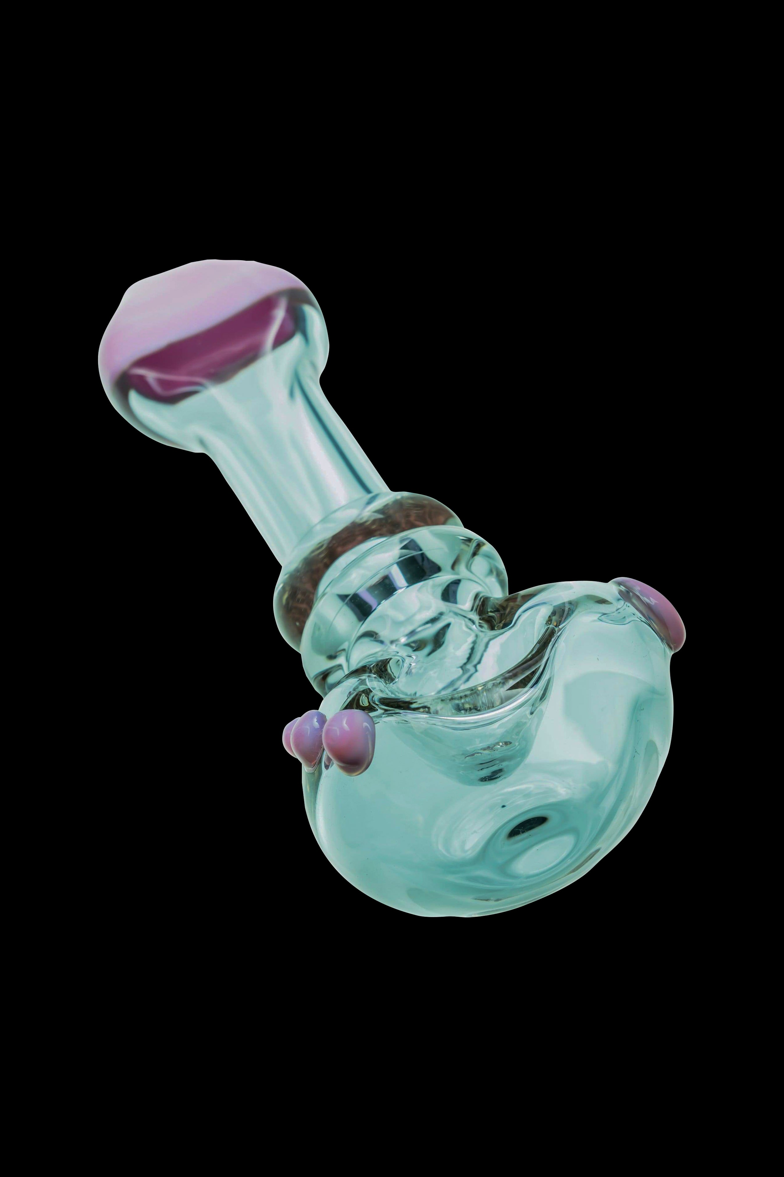 Pale green glass bubbler with purple accents, isolated on a black background.