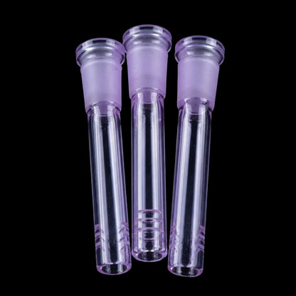 Close-up top-down view of three purple Smoke Cartel Color Diffused Downstem - 3 in. glass tubes against a black background.