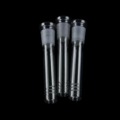 Close-up front view of three Smoke Cartel Color Diffused Downstem - 3 in. glass stems with frosted joints against black background