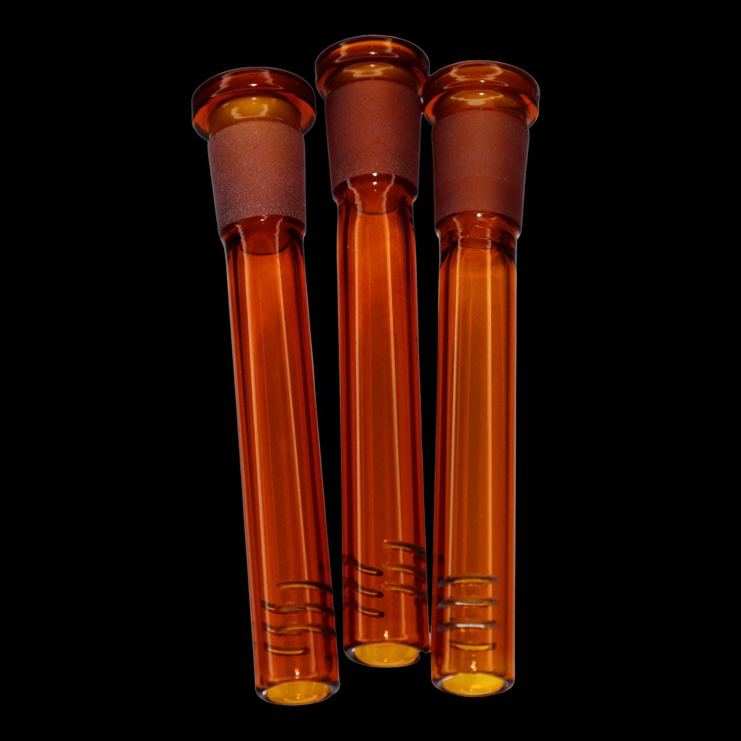 Close-up front view of three amber Smoke Cartel Color Diffused Downstem - 3.5 in. tubes aligned vertically against a black background.