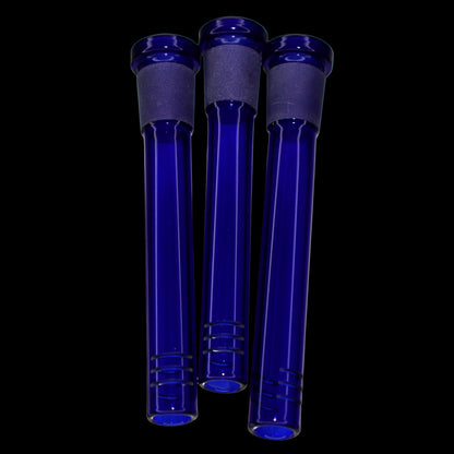 Close-up front view of three blue glass Smoke Cartel Color Diffused Downstem - 3.5 in. tubes against a black background.