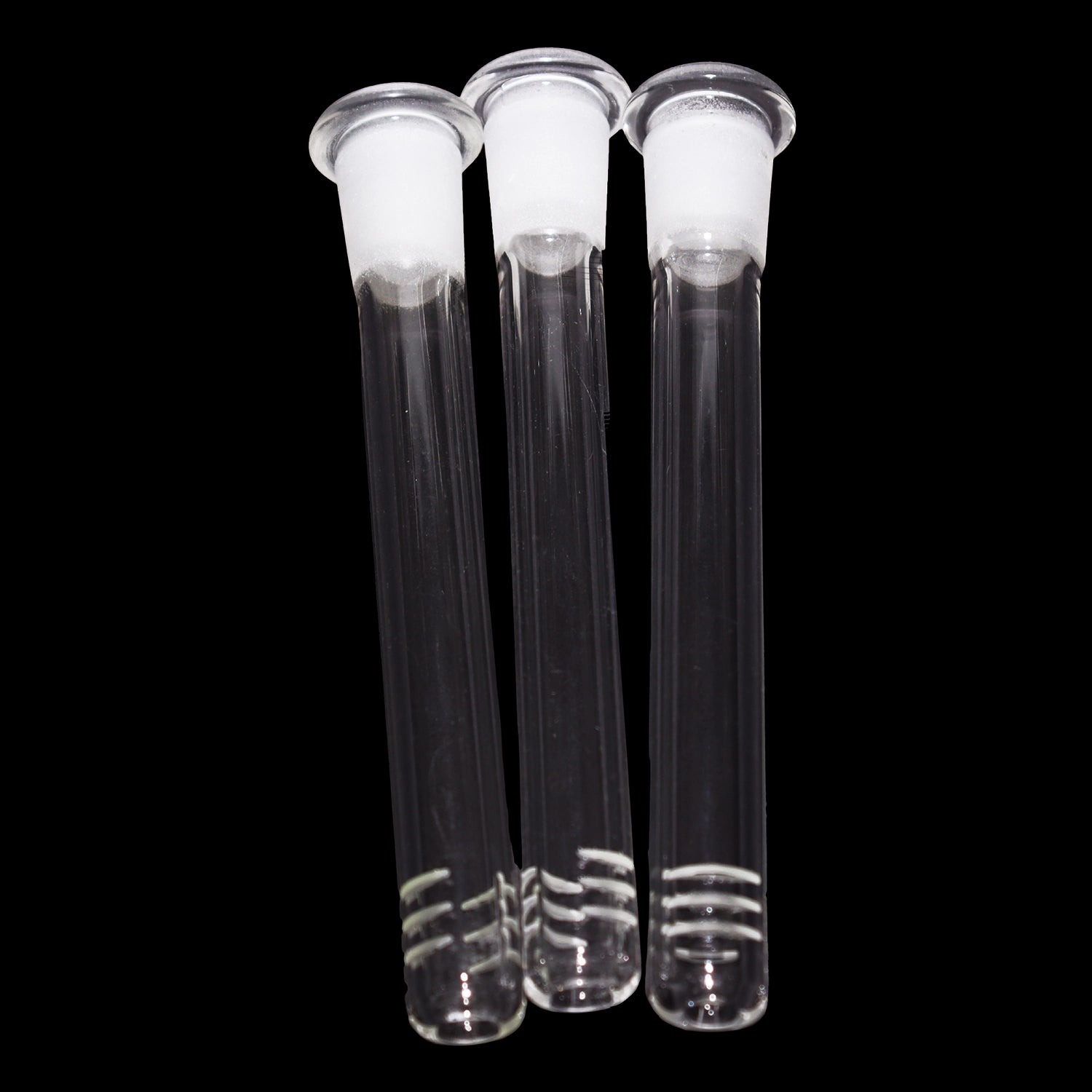 Close-up front view of three Smoke Cartel Color Diffused Downstem - 4.5 in. glass tubes with frosted joints against black.