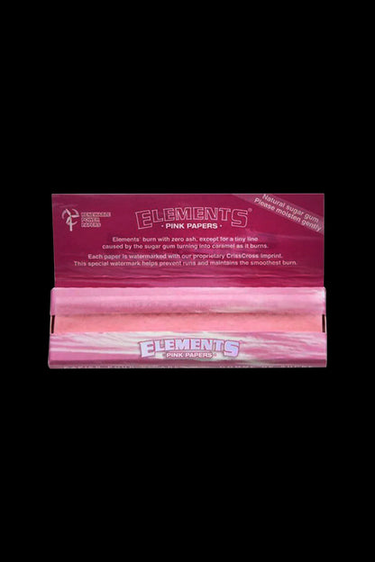 Pack of pink “Elements” rolling papers with text detailing burn quality and sugar gum.