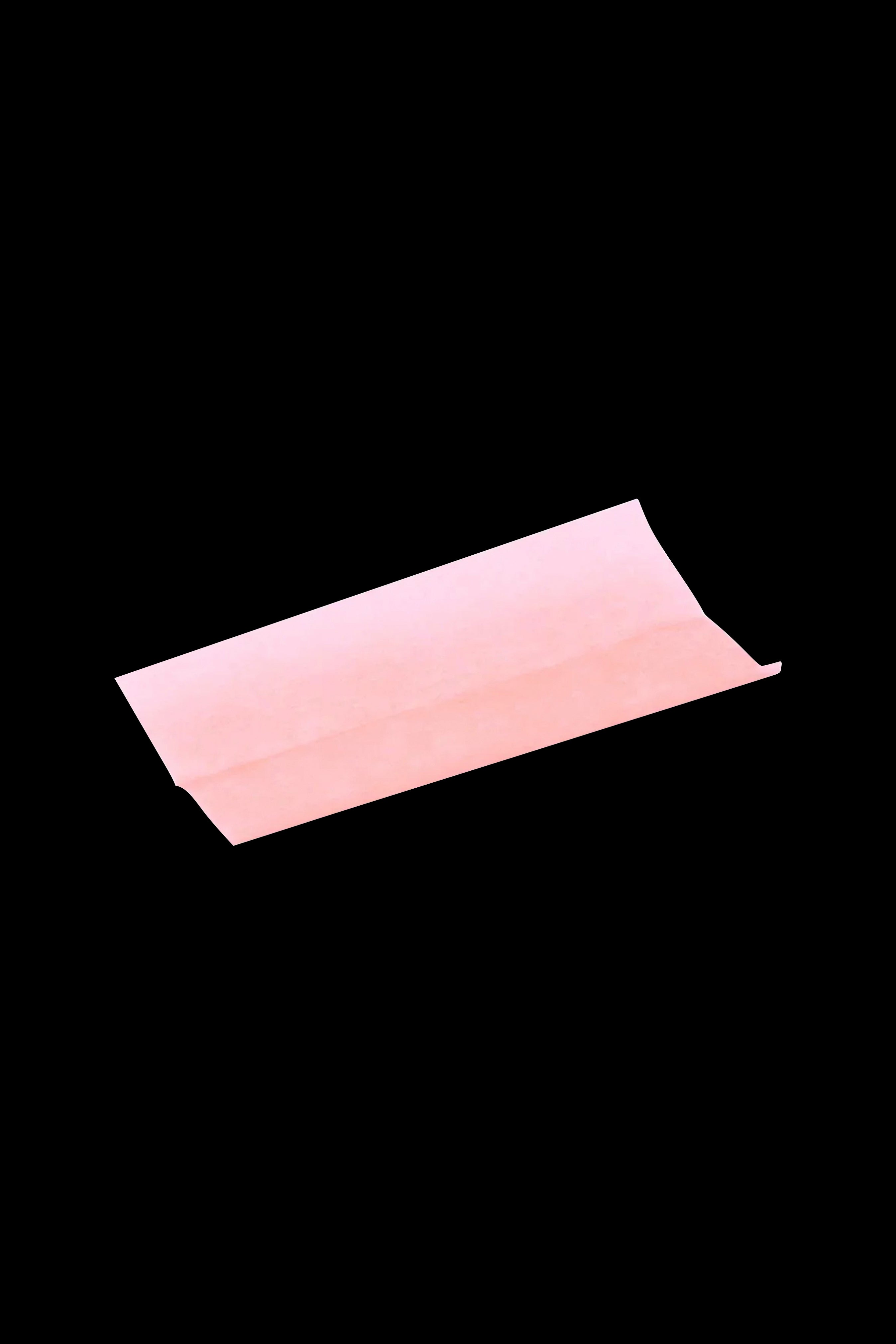 Pink rolling paper roll on a black background.