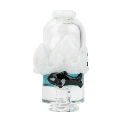 Close-up front view of the Empire Glassworks Puffco Pivot Glass Mouthpiece - Avenge the Arctic showing a clear glass top, white icy sculpted accents and a small black orca over a band of blue.