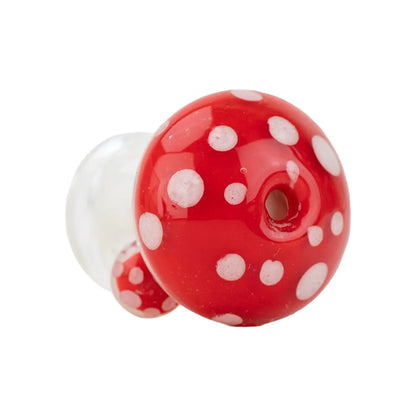 Close-up, angled view of the Empire Glassworks PuffCo Pivot Glass Mouthpiece - Red Mushroom showing its red, white-spotted mushroom cap and central mouth opening.