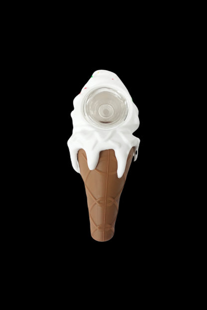 Ice cream cone-shaped glass pipe with dripping white “ice cream” against a black background.