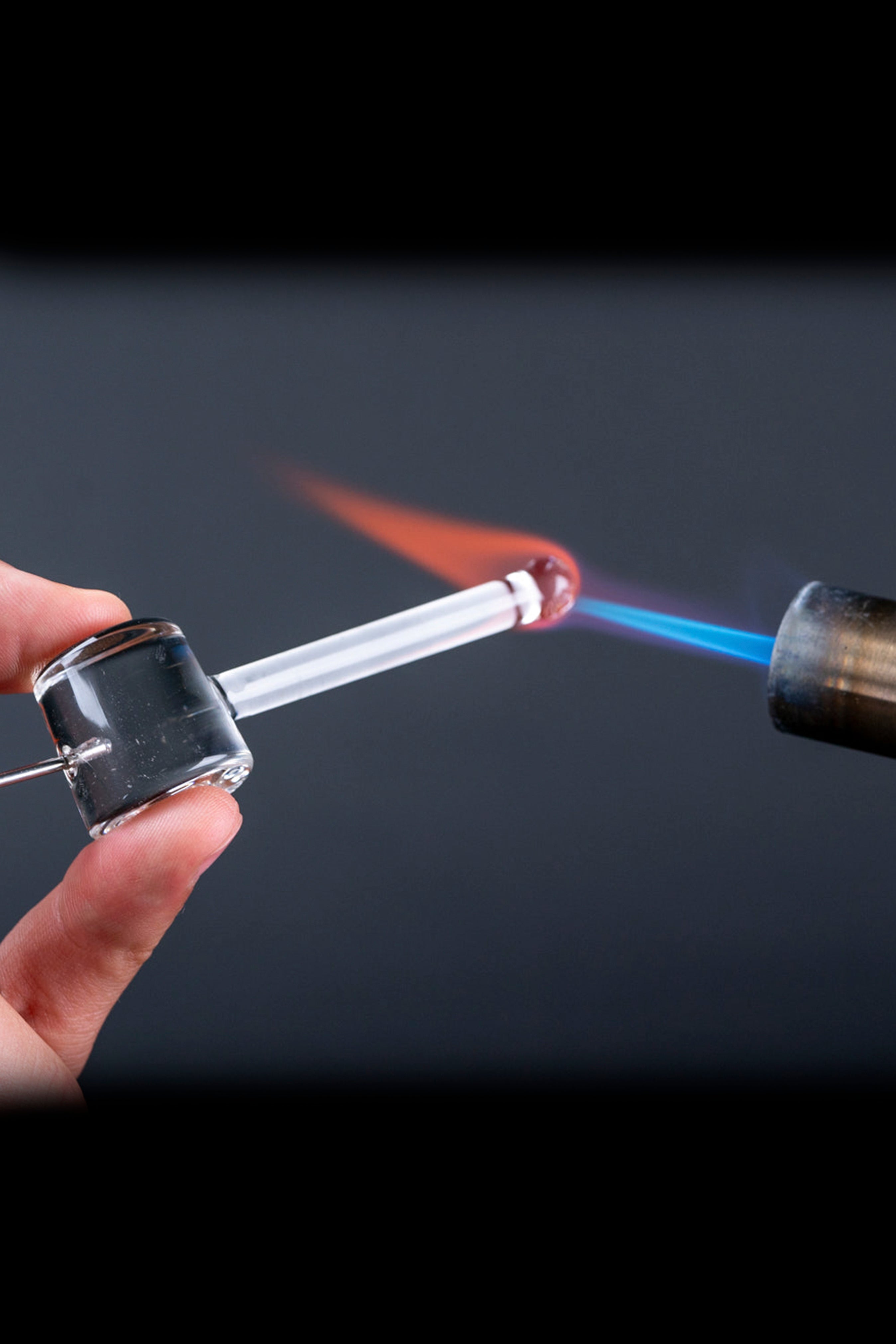 Dab rig being heated with a torch, showing glowing concentrate and blue flame.