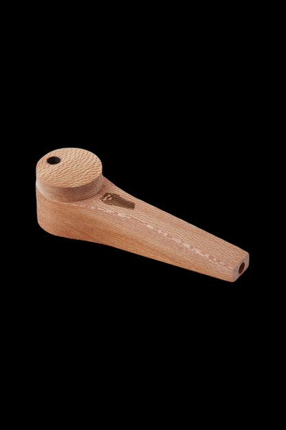 Wooden cannabis pipe on a black background.