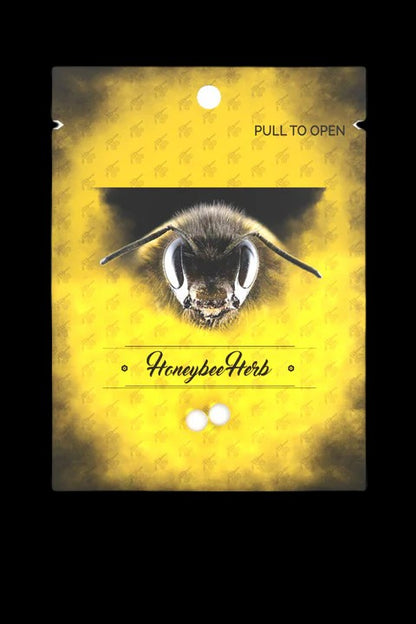 Close-up of a bee's face on a yellow textured background with the text "HoneybeeHerb."