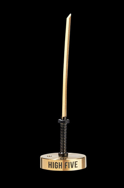 Gold katana-style dab tool with “HIGH FIVE” text on the base, against a black background.