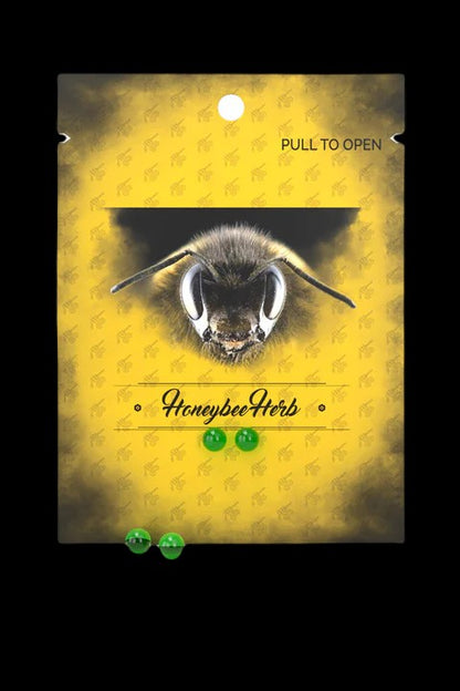 Yellow cannabis packaging with a close-up of a bee's face and text reading ""Honeybee Herb.""