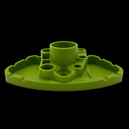 Low-angle front view of a purple Blazy Susan Deluxe Dab Station with multiple circular wells and raised center cup against black background