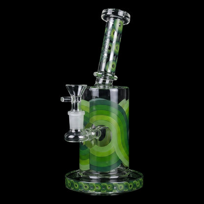Angled close-up of the Croia Glass Retro Scientific Bong with Matrix Perc showing its green concentric-ring patterns on a tilted clear neck and matching decorative base against a black background