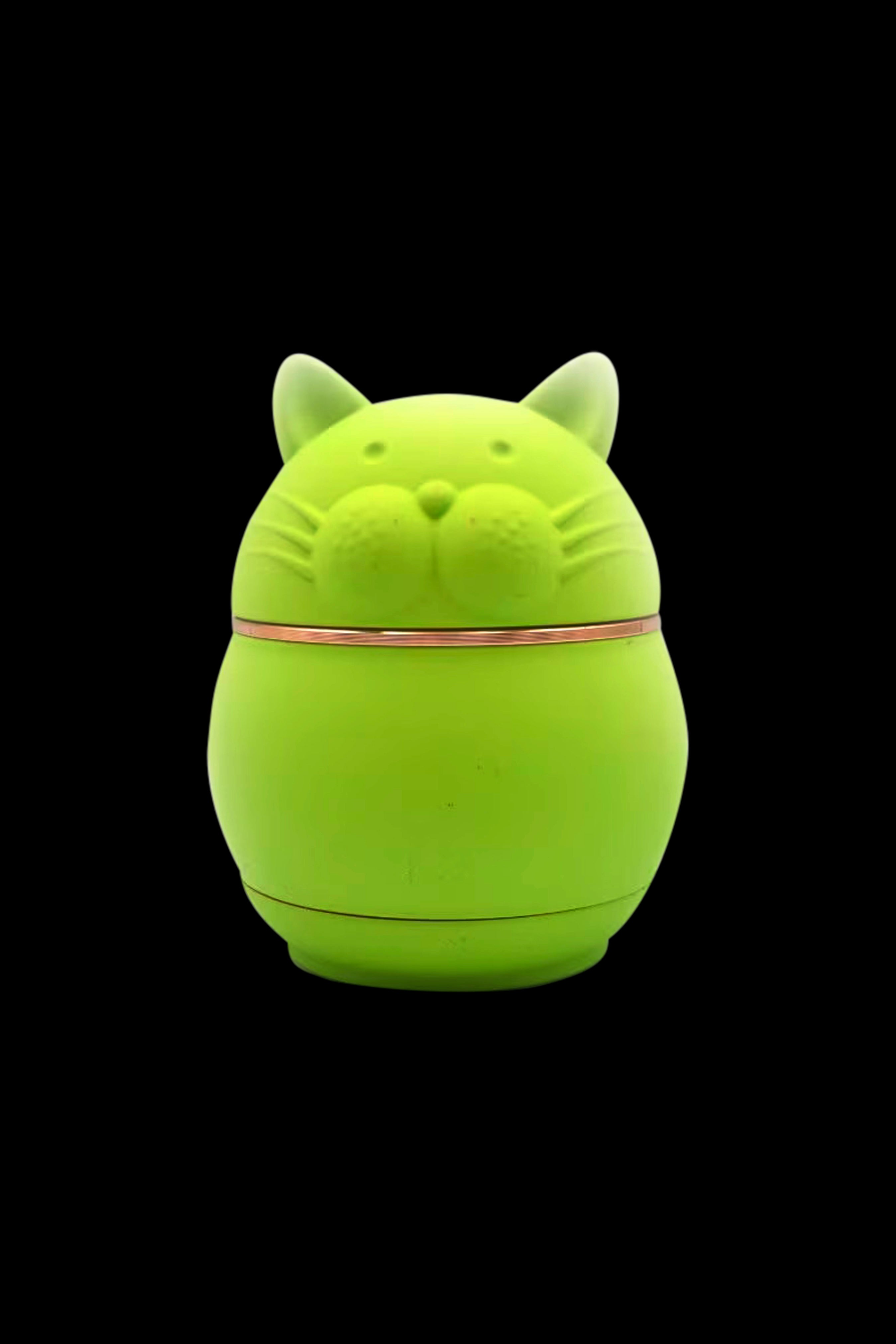 Green cat-shaped silicone container for cannabis concentrates.