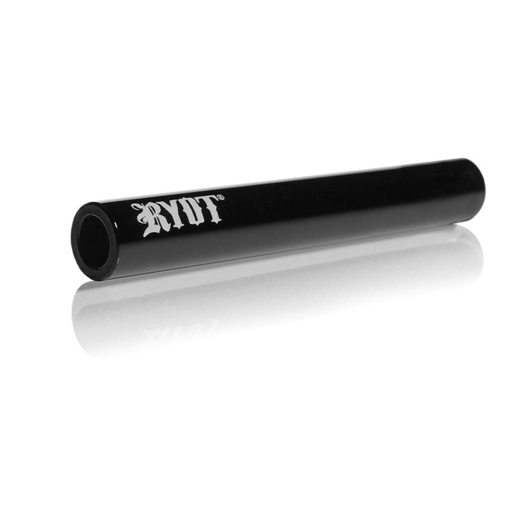 Angled close-up of the black RYOT Ceramic Maple Traveller Pipe resting on a reflective white surface, showing its hollow end and white RYOT logo.