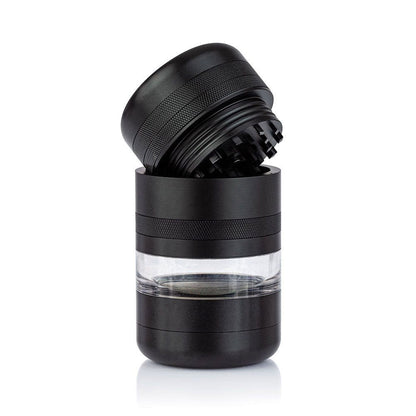 Angled close-up of the black RYOT GR8TR Jar Body Grinder with its top open, showing textured grip and clear middle chamber