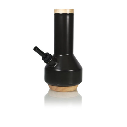Centered front view of the RYOT Ceramic Maple Traveller Pipe in matte black with wooden top and base on a white reflective surface