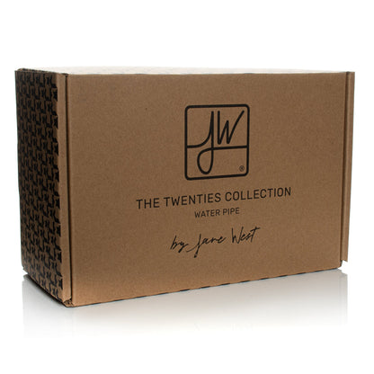 Brown cardboard box for “The Twenties Collection” water pipe by Jane West, featuring a repeating cannabis leaf pattern on the side.