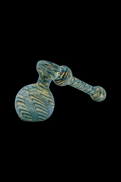 Green and gold glass bubbler pipe against a black background.