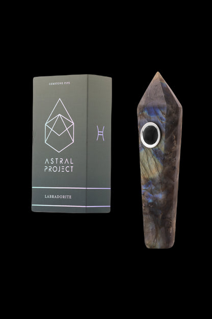 Labradorite gemstone pipe and its branded packaging, presented against a black background.