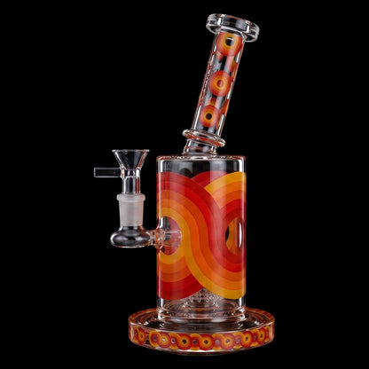 Angled close-up of the Croia Glass Retro Scientific Bong with Matrix Perc | Croia Glass showing its red concentric circle pattern on a clear glass body against a black background