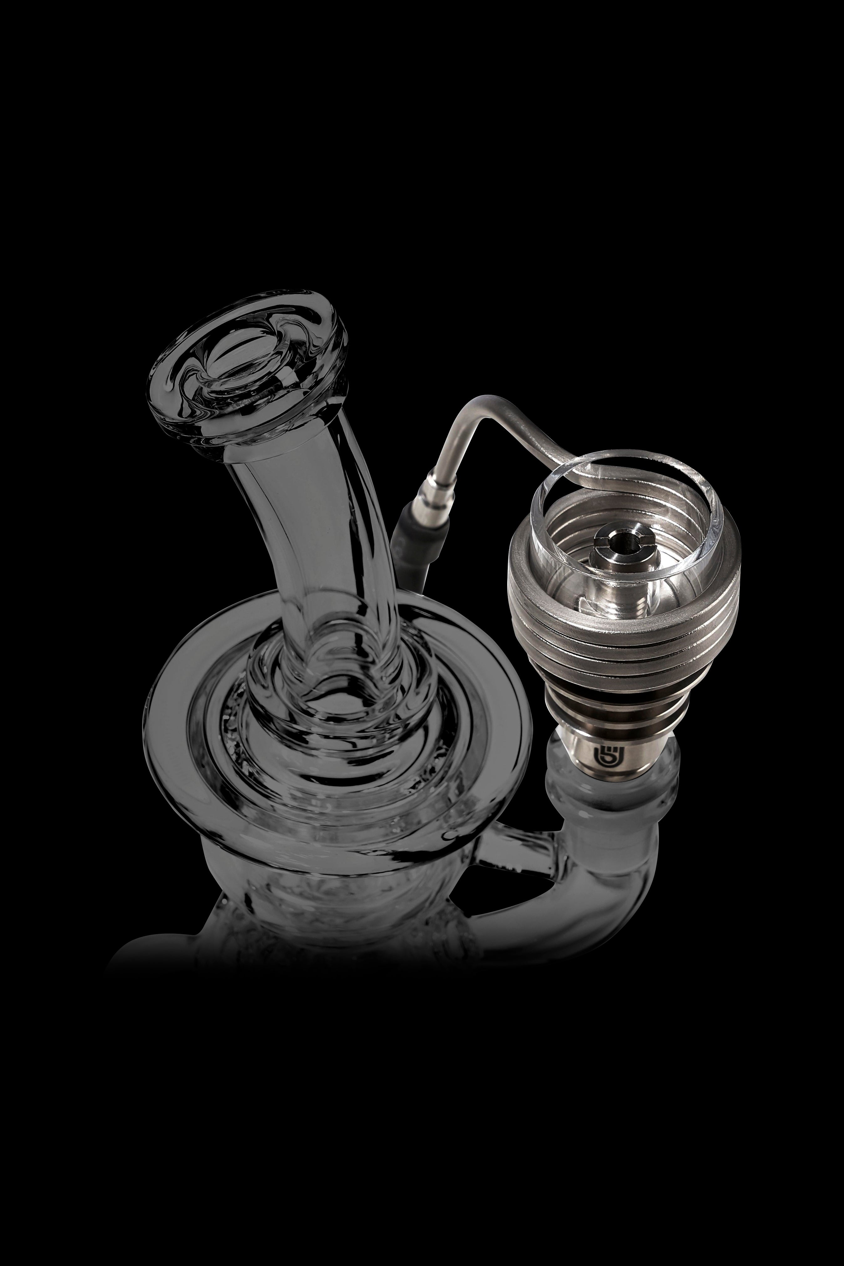 Clear glass dab rig with a bubbler and quartz banger.