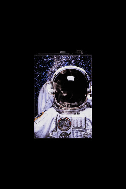 Astronaut helmet-shaped cannabis container against a starry background.
