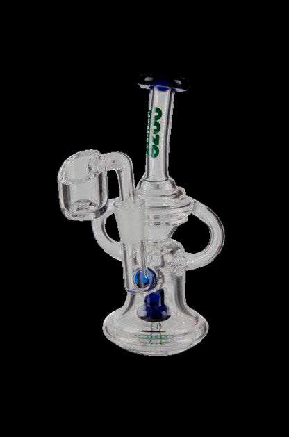 Clear glass dab rig with intricate percolator and quartz banger.