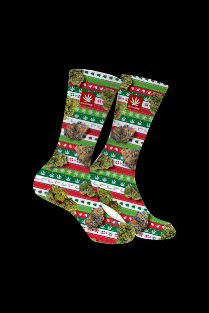 Cannabis-themed socks with a festive, patterned design resembling a Christmas sweater, featuring marijuana leaf motifs and buds."