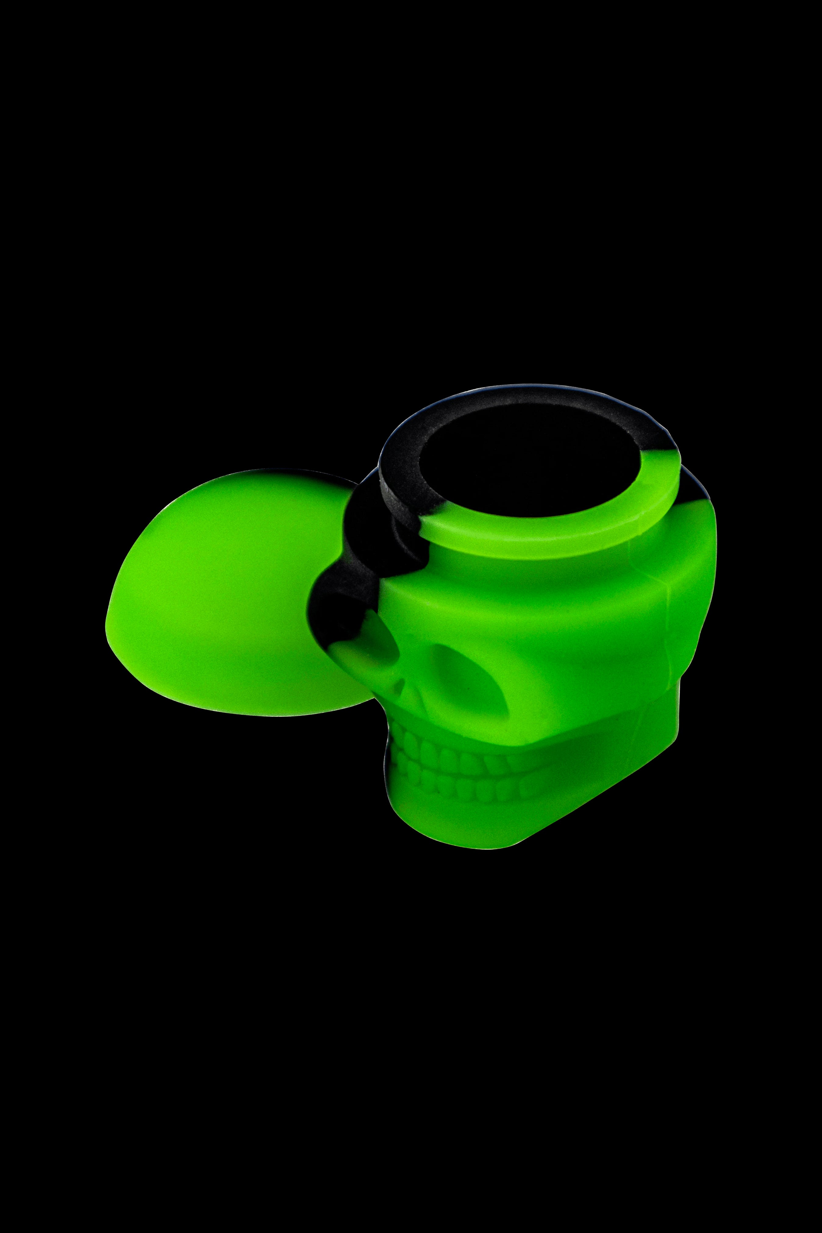 Green silicone skull-shaped container with a black lid.