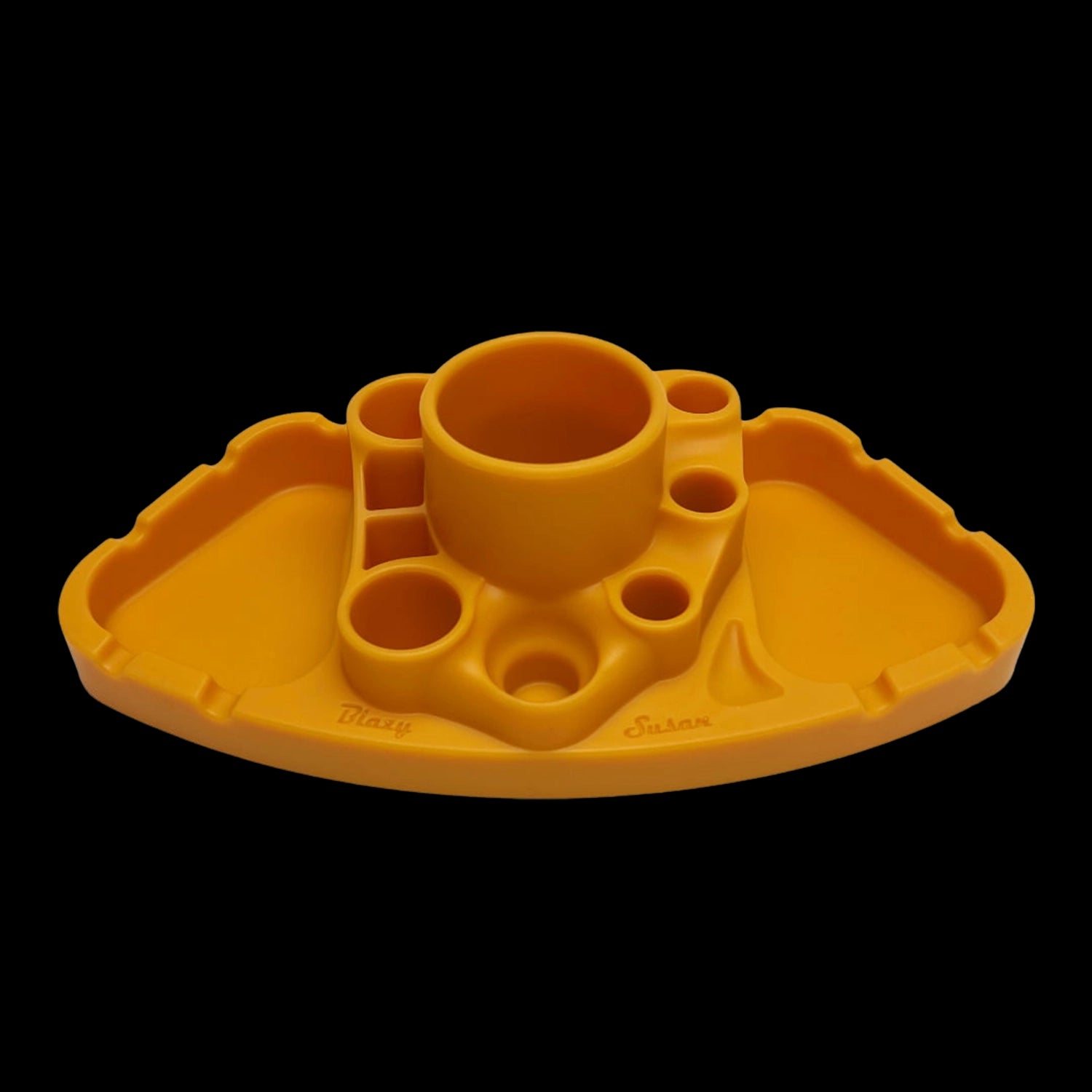 Front-facing view of a black-background orange Blazy Susan Deluxe Dab Station with multiple round wells and a central cup.